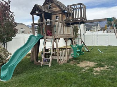 Large Wooden Swing Set Playhouse with Slide, Swings, and Rock Wall - Backyard Playset