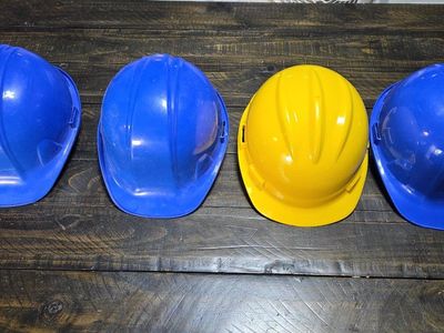 Safety Gear Lot: Hard Hats (Blue, Yellow) & Reflective Vests (High-Vis Green, Orange)