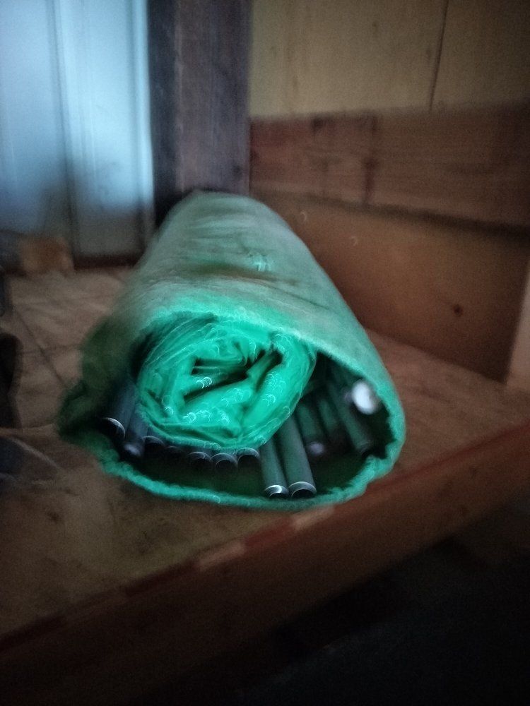 Used Rolled Green Tent with Metal Poles and Protective Cover