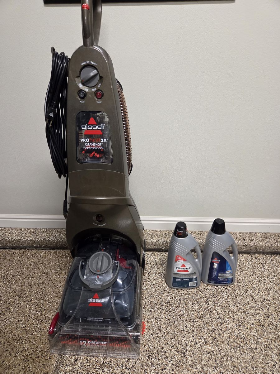 Bissell Carpet Cleaner machine plus cleaner concentrate.