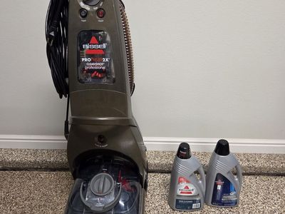 Bissell Carpet Cleaner machine plus cleaner concentrate.