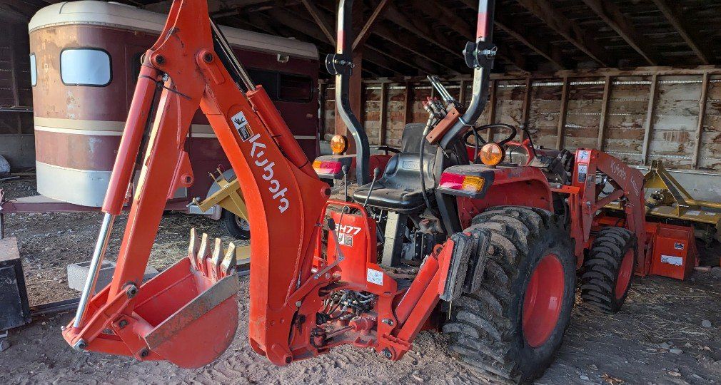 Tractor with Loader, Backhoe, Tiller, Scraper, Fence Post Auger, Brush Hog, and Operator for Hire