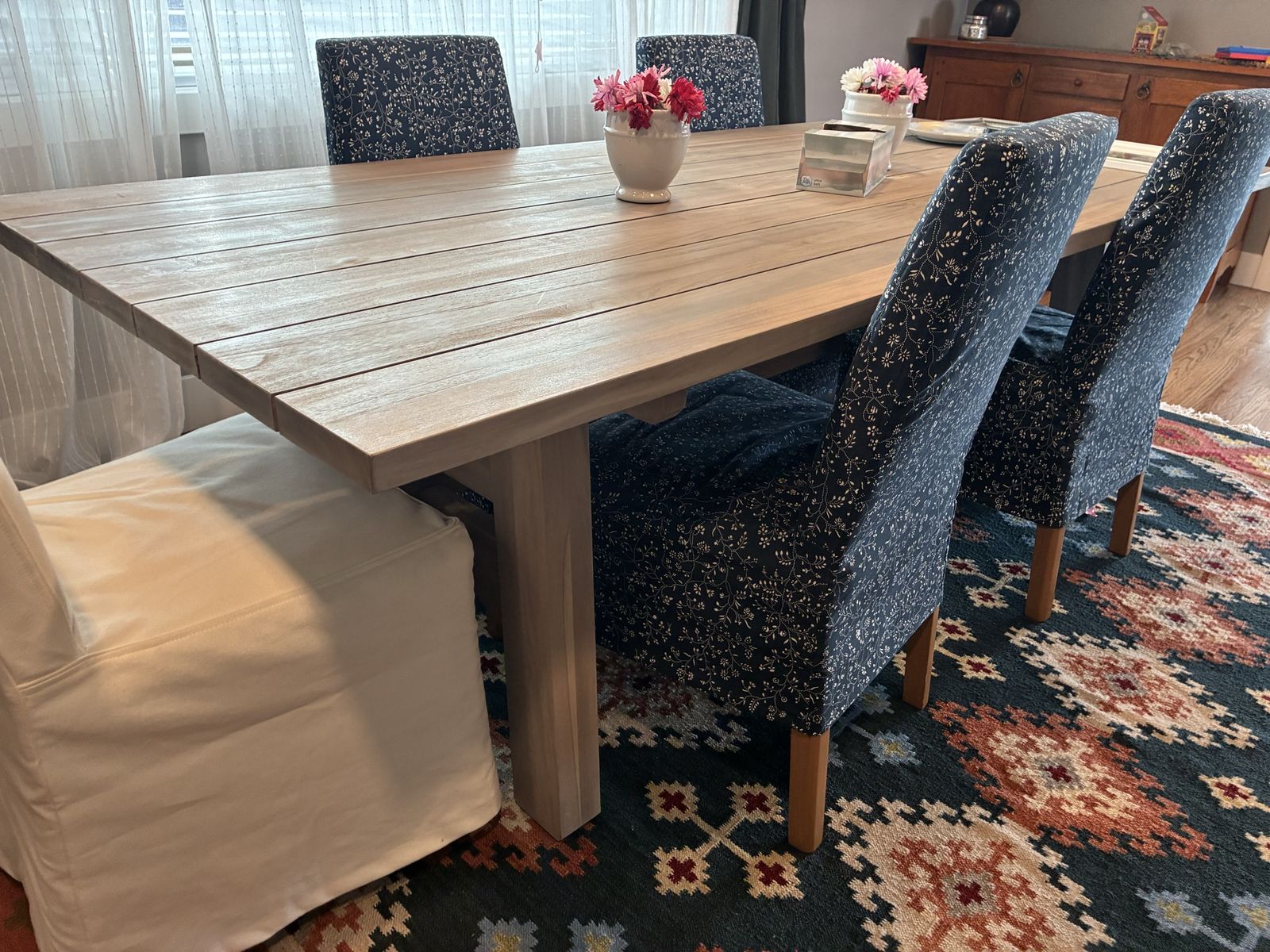 Restoration Hardware Outdoor/Indoor Dining Table with 8 Chairs and Slipcovers - Light Wood Finish, Floral and White Slipcovers