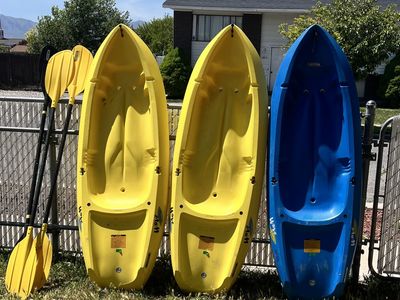 Youth kayaks with paddles