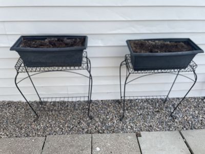 2 matching iron plant stands with planters (and soil in it)