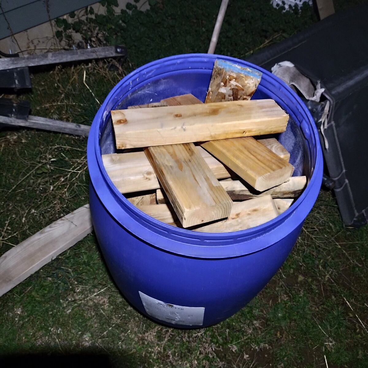 Barrels full of firewood and loose wood