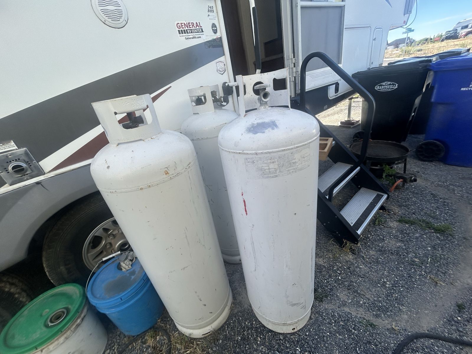 3 empty propane tanks