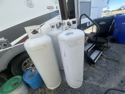 3 empty propane tanks
