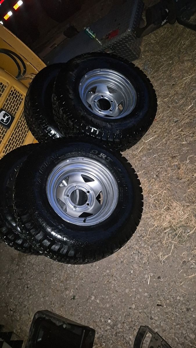 Set of 4 All-Terrain Tires Mounted on Silver Steel Wheels Rims