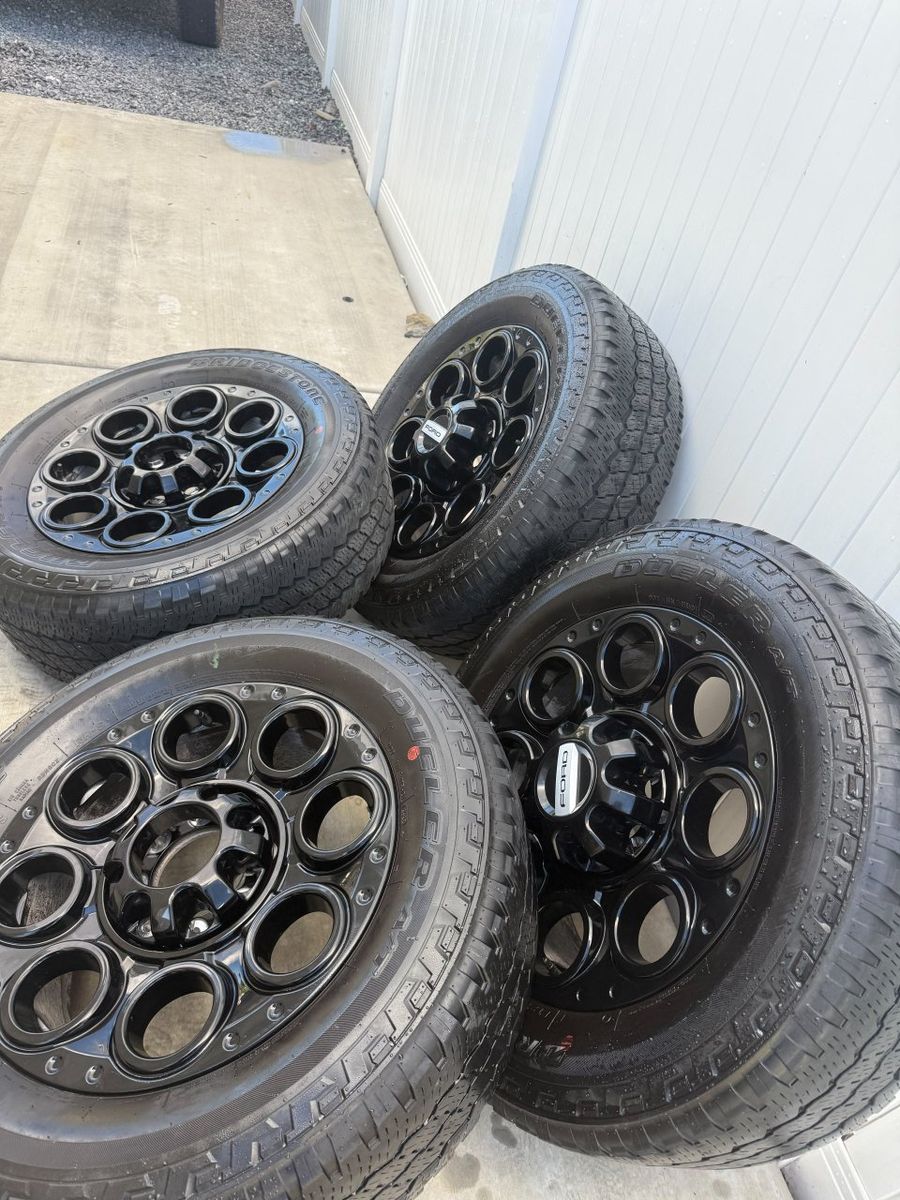Set of 4 Ford f350 Black Beadlock Capable Wheels w/ Bridgestone Dueler A/T Tires 20 inxh 8x170