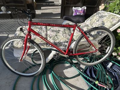 This red Jamis mountain bike features a rigid steel frame and appears consistent with models from the late 1990s - Red, 26-inch