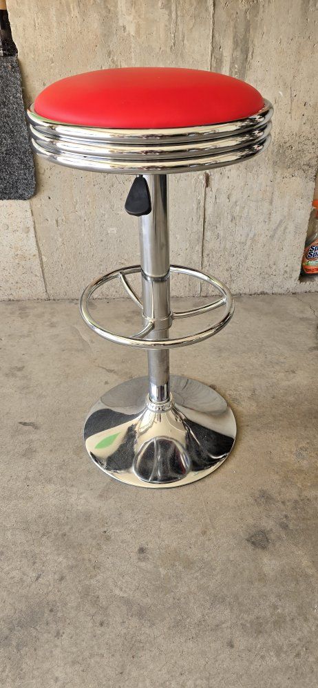 Red Swivel Bar Stool with Chrome Finish, Adjustable Height, and Footrest