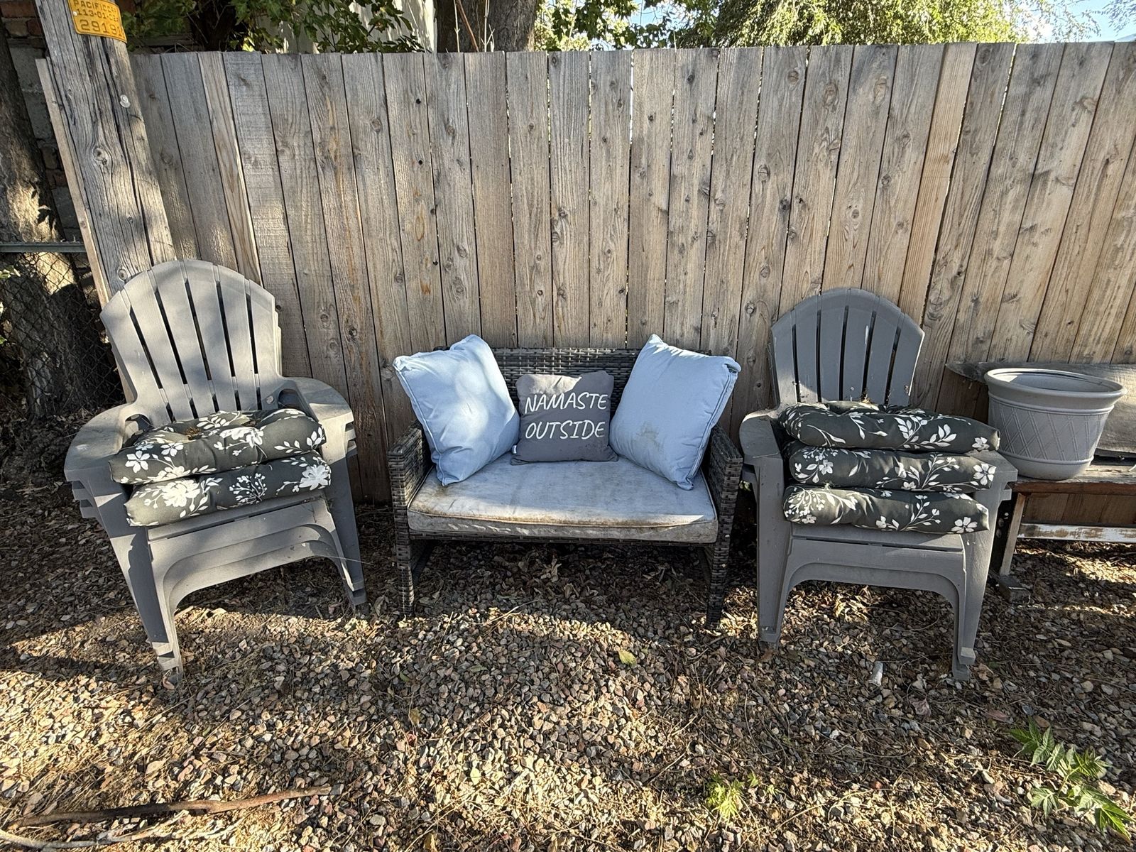 Two wicker love seats and five patio chairs