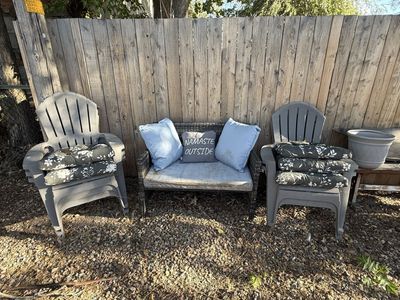 Two wicker love seats and five patio chairs