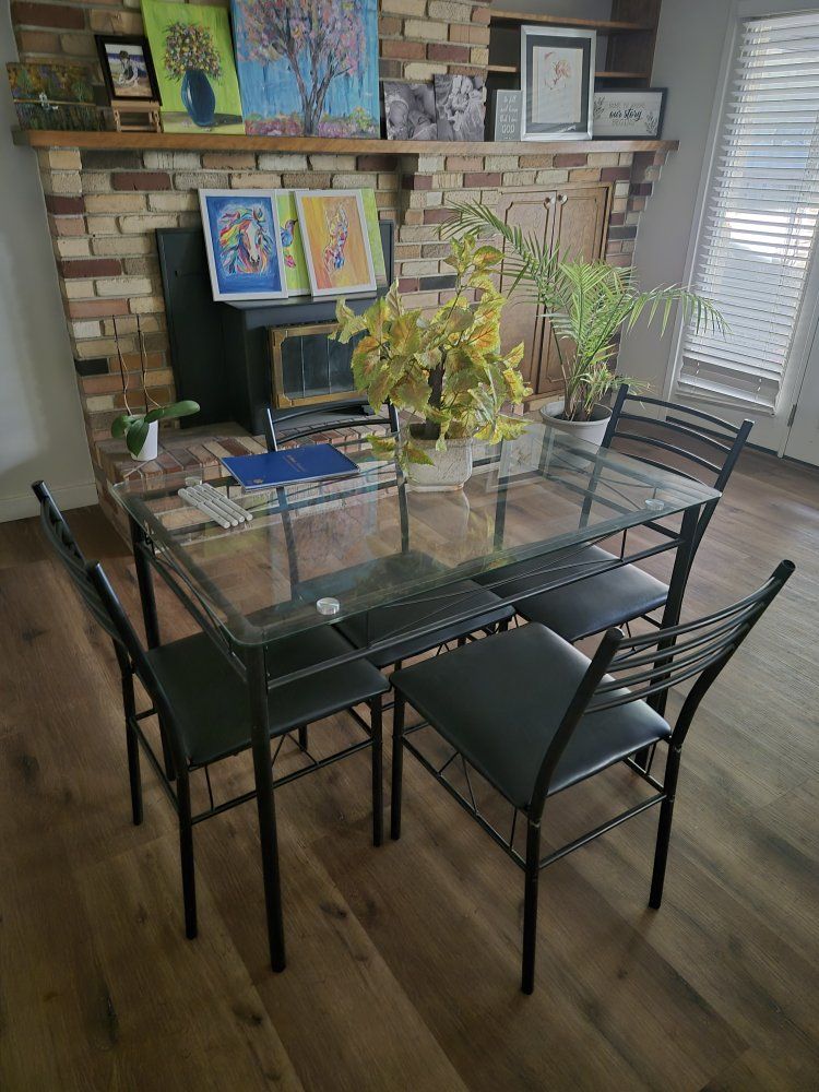 Modern Glass Top Dining Table with Four Black Metal Chairs