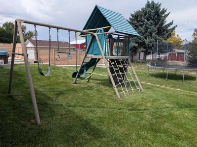 Outdoor Metal and Plastic Playset with Slide, Swings, and Climbing Wall