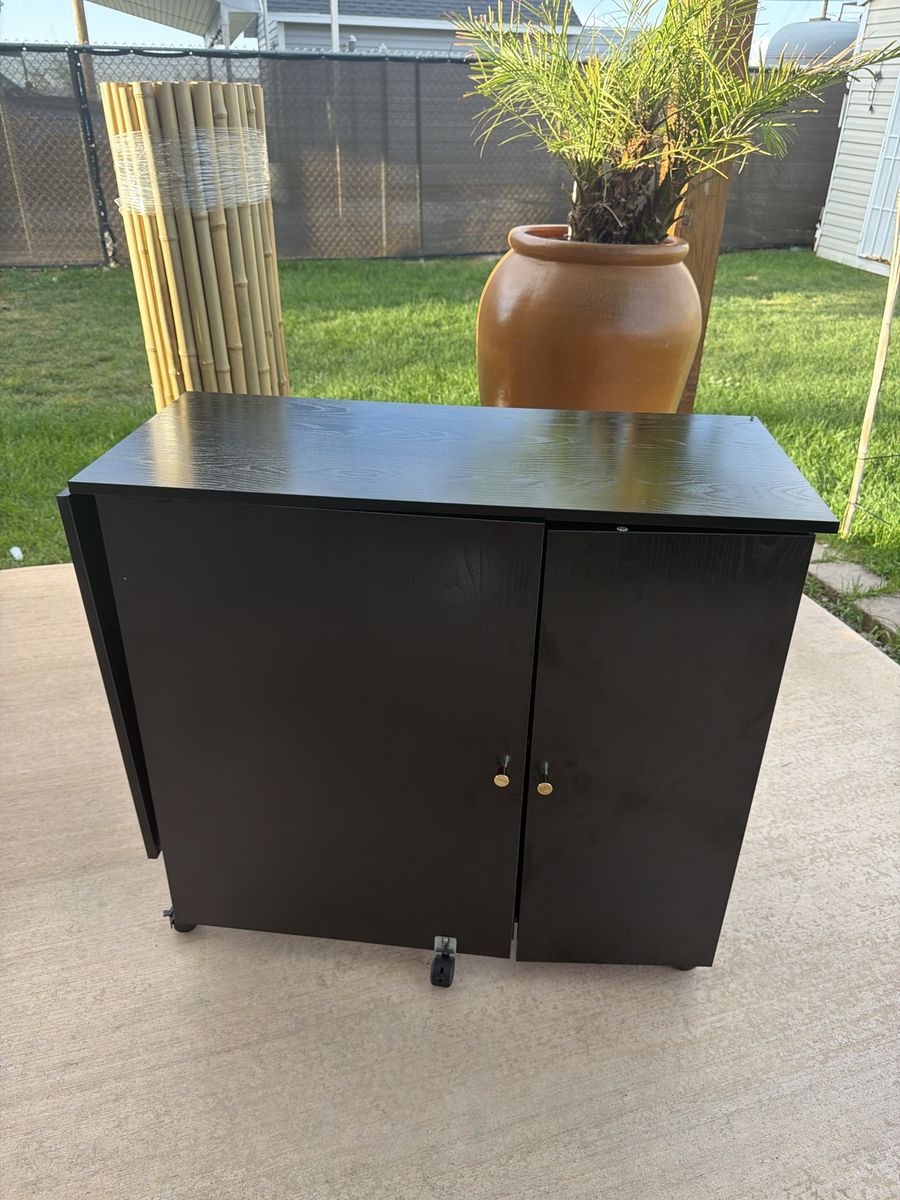 Black Folding Sewing Cabinet and Craft Desk with Storage and Wheels