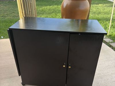 Black Folding Sewing Cabinet and Craft Desk with Storage and Wheels