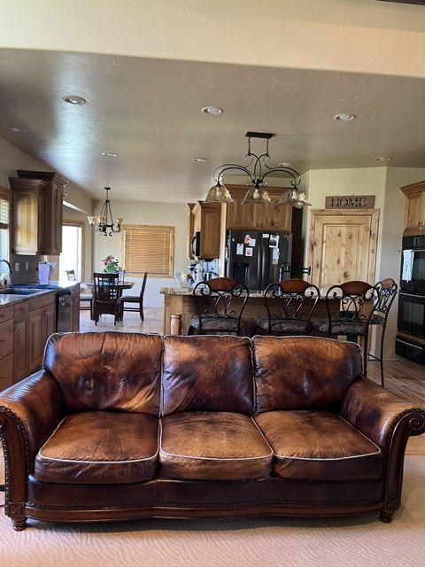 Vintage Brown Leather Sofa Couch with Nailhead Trim and Carved Wood Accents