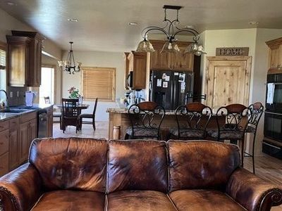Vintage Brown Leather Sofa Couch with Nailhead Trim and Carved Wood Accents