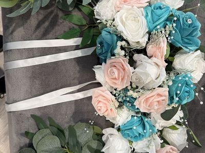 Wedding arch topper & lots of flower garlands & netting used for back drop & fabric/ribbon to decorate with