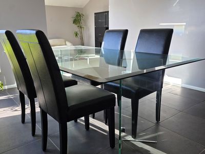 Glass Dining Room Table with Four Leather Chairs