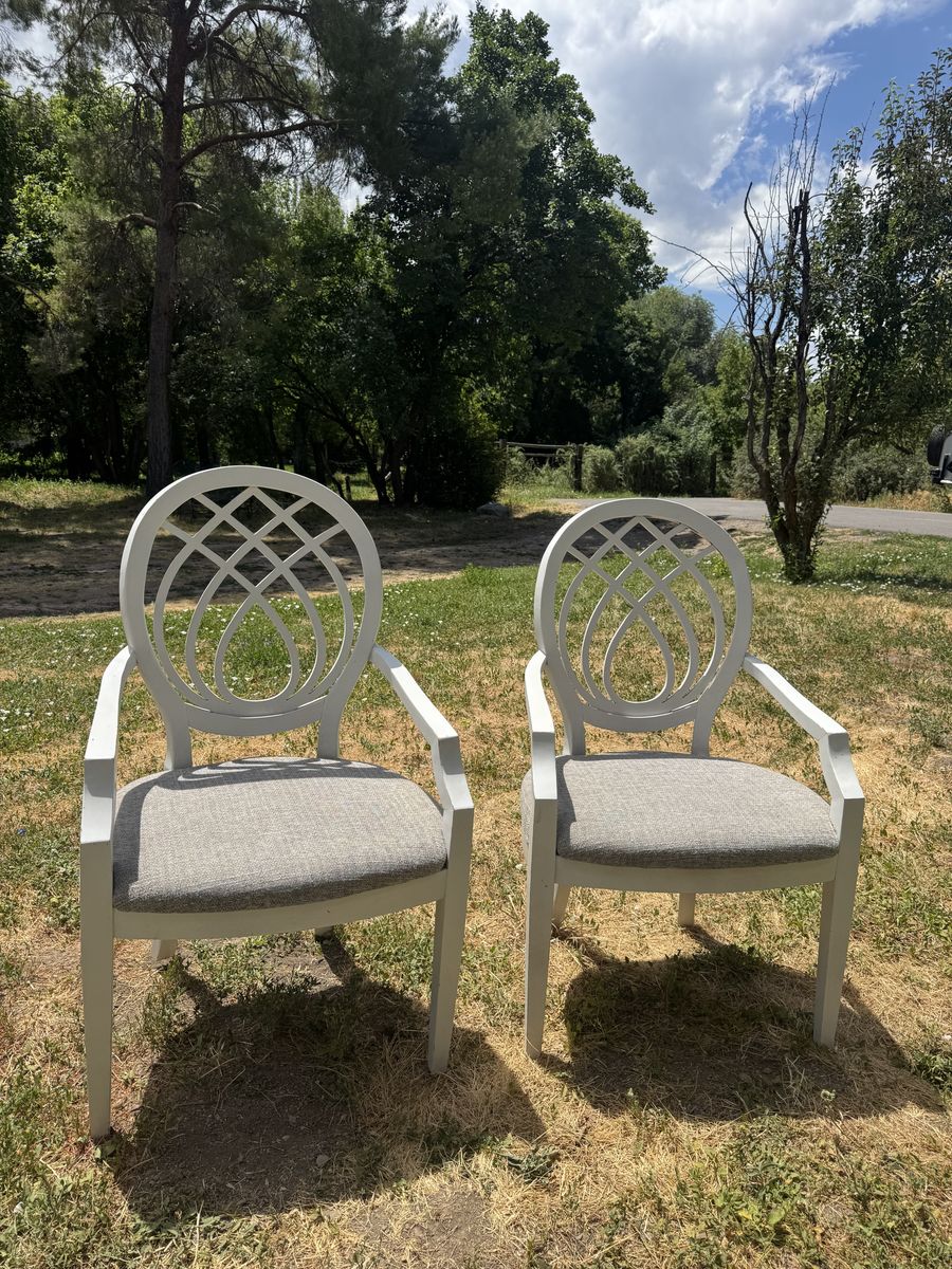 Two classic sturdy white chairs with cushions
