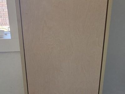 Ikea natural-color cupboard sits on floor 17L x23W ×54.5H by downtown