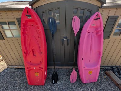 Youth sit on Kayaks