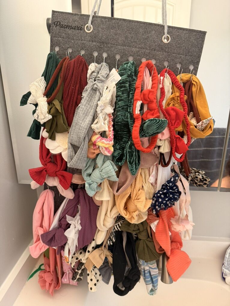 Barely used baby/toddler headbands and holder.