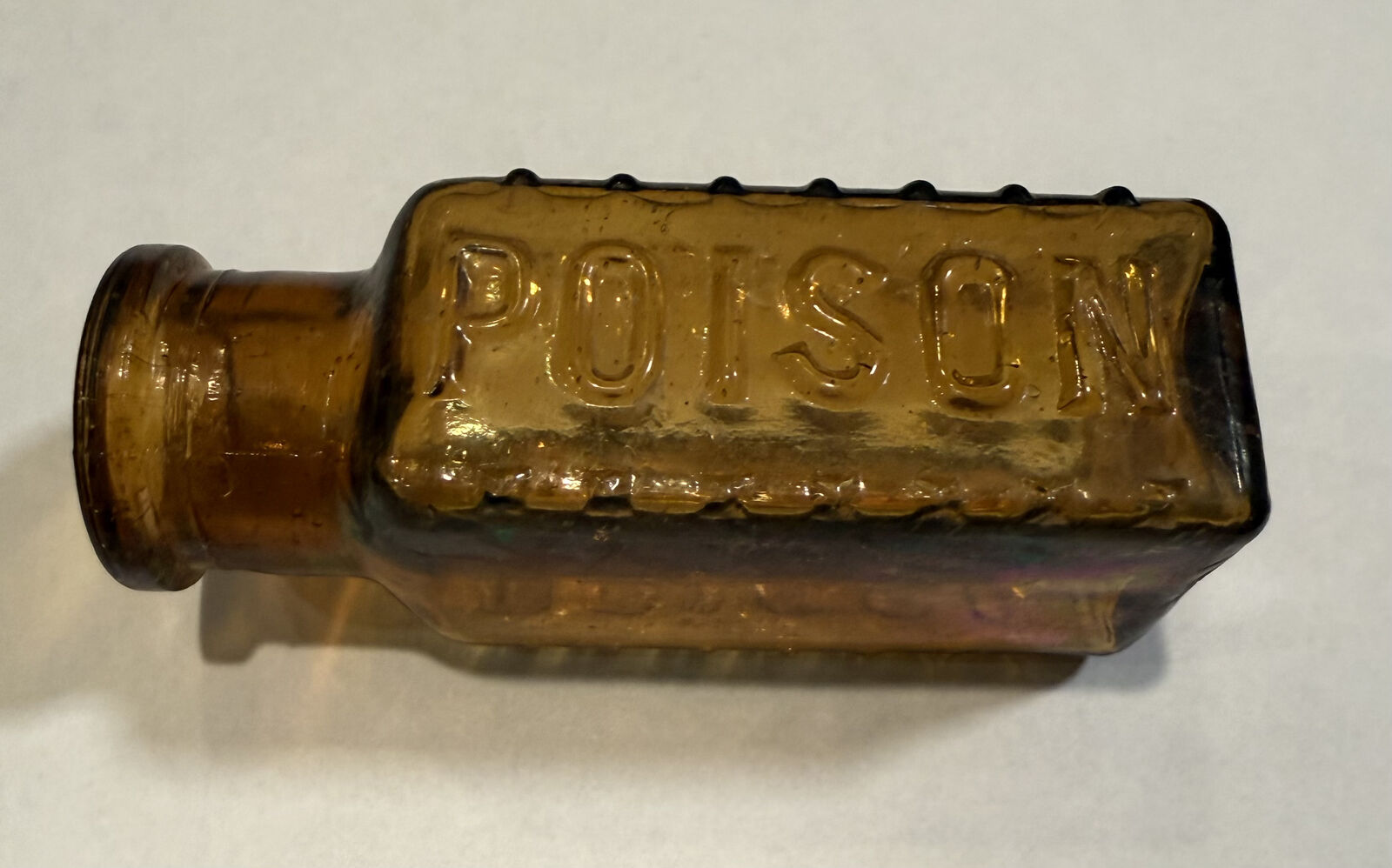 Vintage 4-Sided (2 3/4" tall) Amber Poison Embossed Bottle