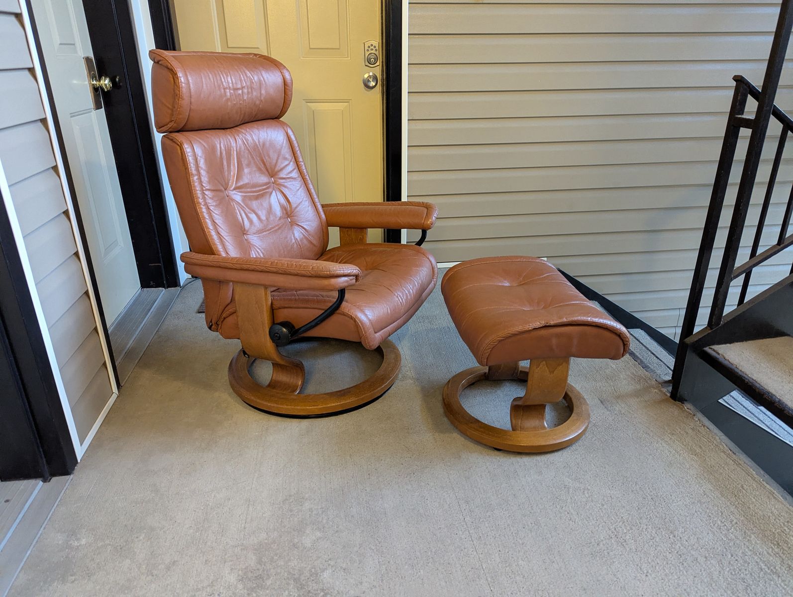 ekornes stressless recliner and ottoman set in cognac leather.