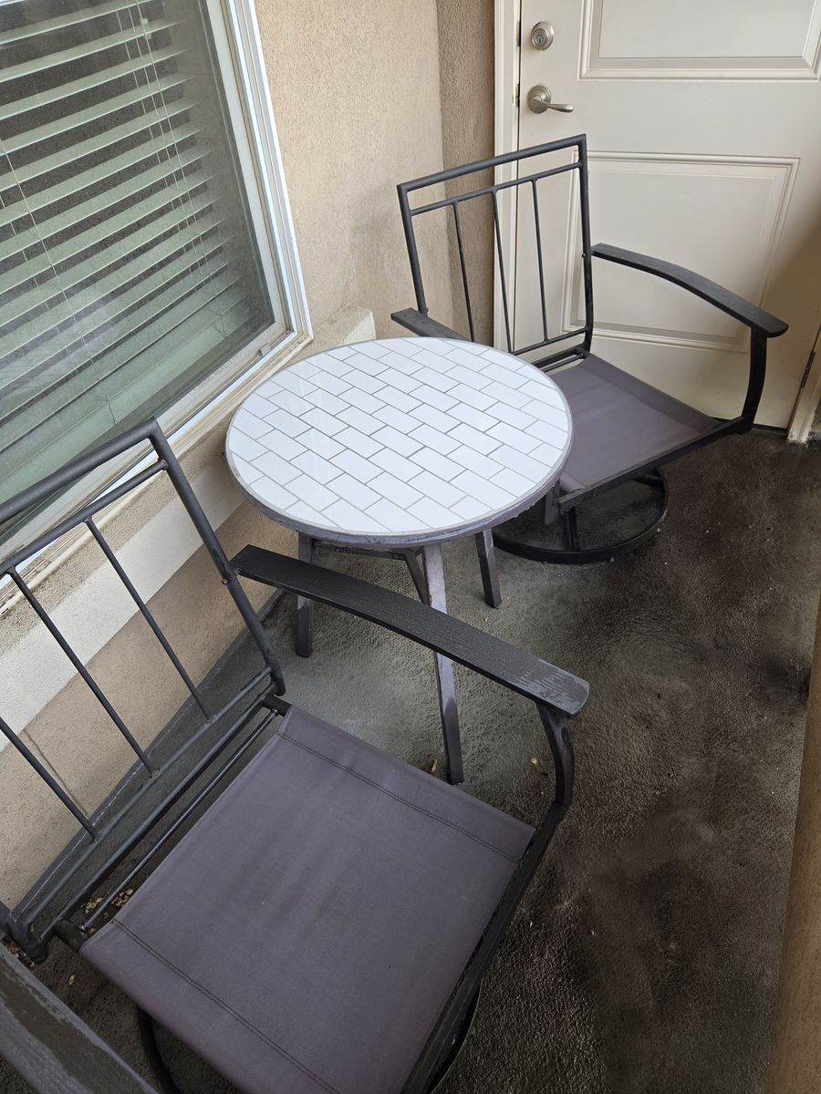 Swivel patio chairs and tiled table
