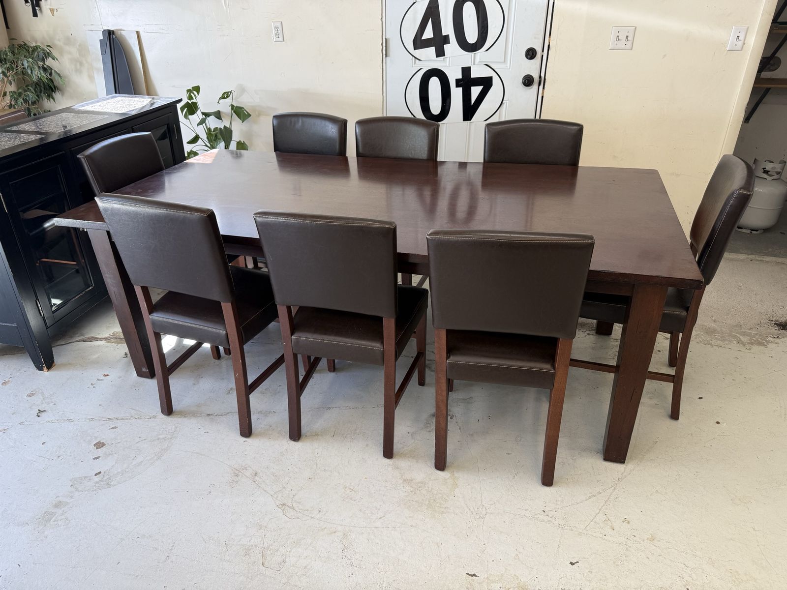Dark Wood Dining Table with 8 Brown Faux Leather Parson Chairs