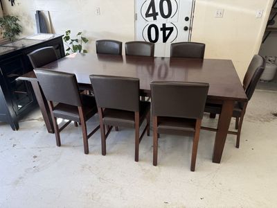 Dark Wood Dining Table with 8 Brown Faux Leather Parson Chairs