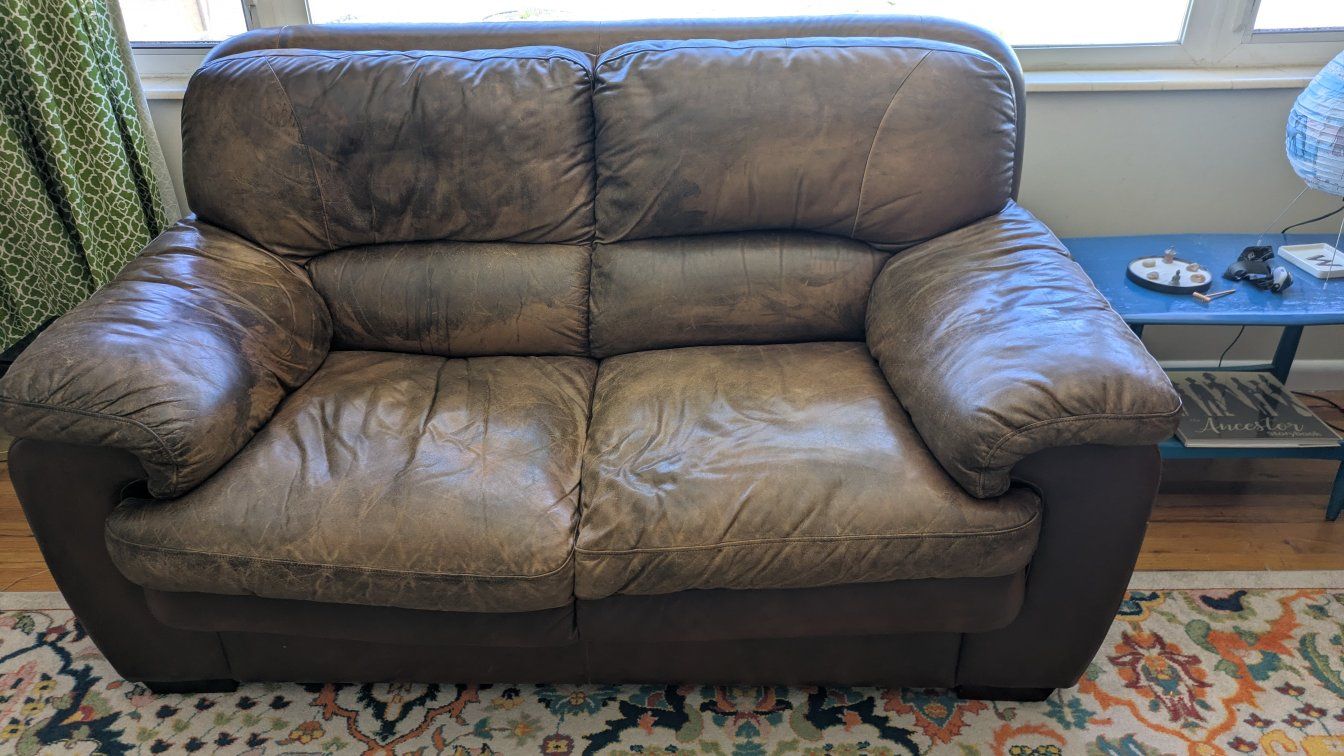 Brown leather couch and loveseat