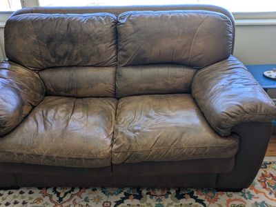 Brown leather couch and loveseat