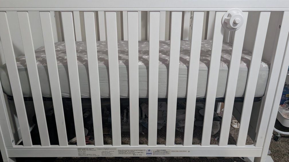 crib and mattress and mobile