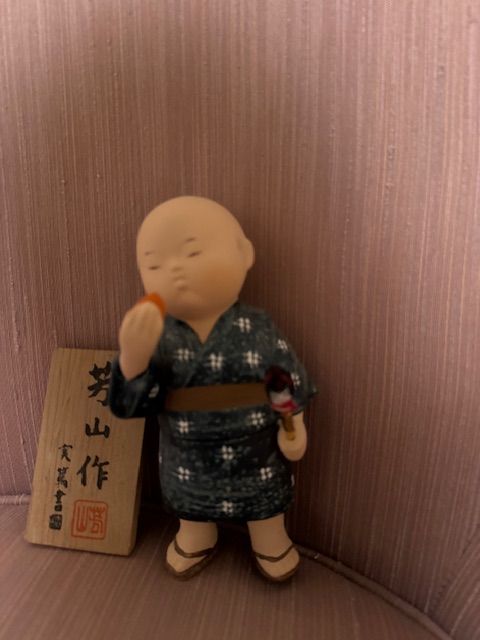 Japanese collectible doll/figurine, likely a ceramic or resin okimono-style figure