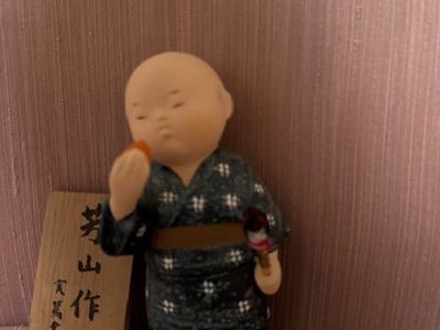 Japanese collectible doll/figurine, likely a ceramic or resin okimono-style figure