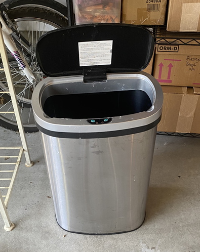 Trash can with automatic lid
