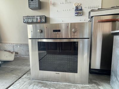 Viking Stainless Steel Kitchen Appliance Set: Wall Oven, Gas Cooktop, Beverage Cooler, Trash Compactors, and Proofing Drawer.