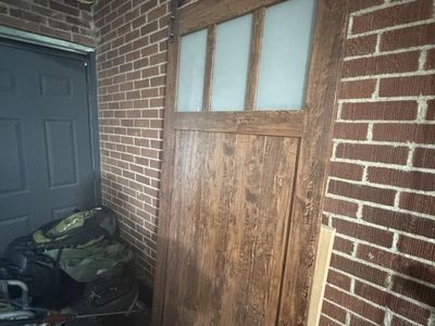 Interior sliding barn door with track