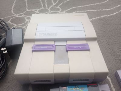 Super Nintendo console, two controllers and 10 games
