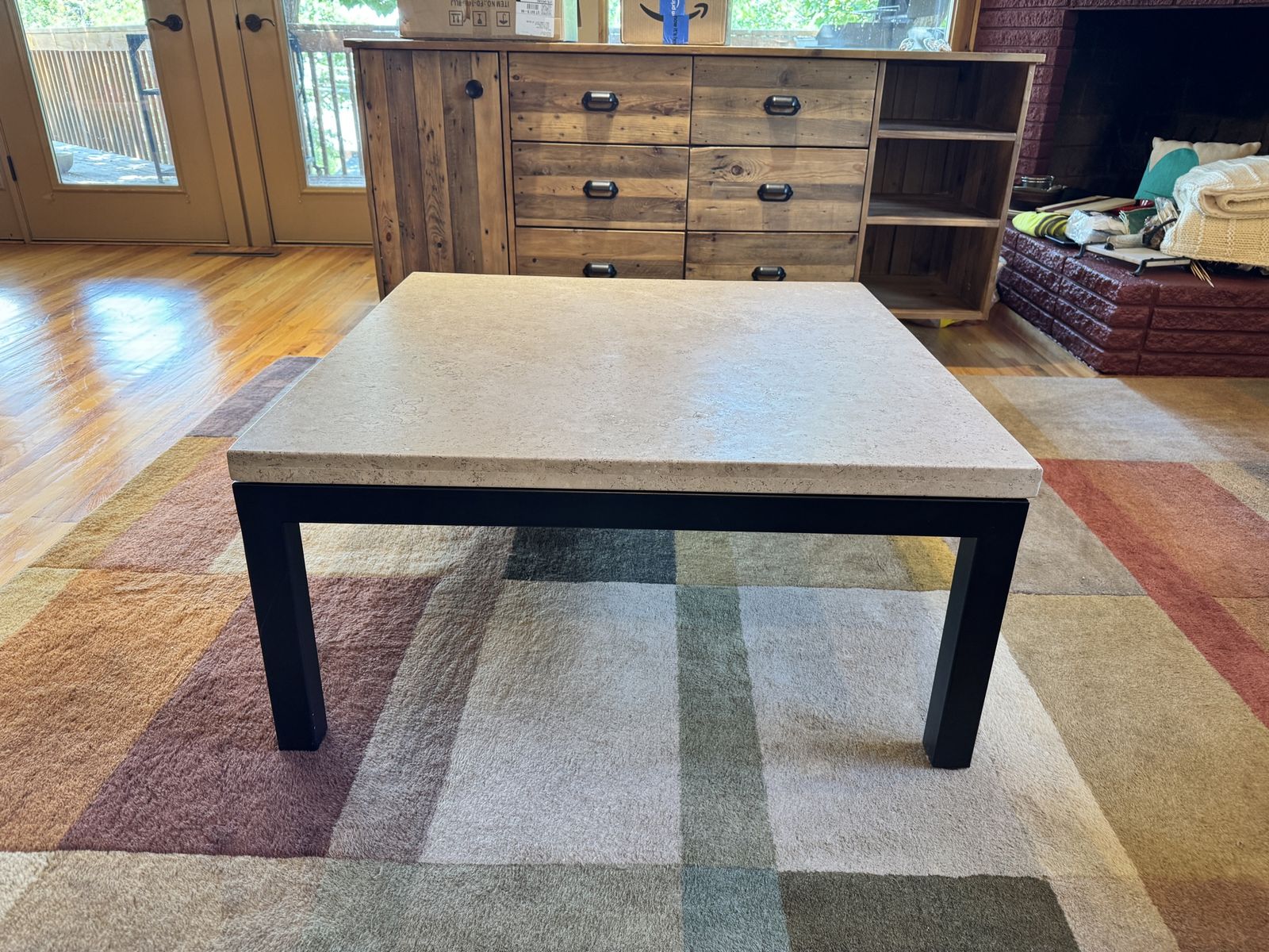 Crate & Barrel Modern Square Travertine Top Coffee Table with Black Metal Base.