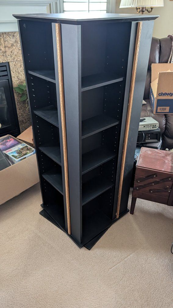 Two rotating black bookshelves