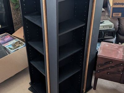 Two rotating black bookshelves
