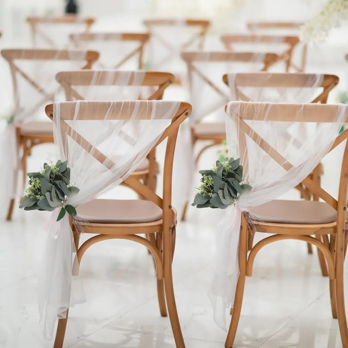 24 Chair sashes with greenery.