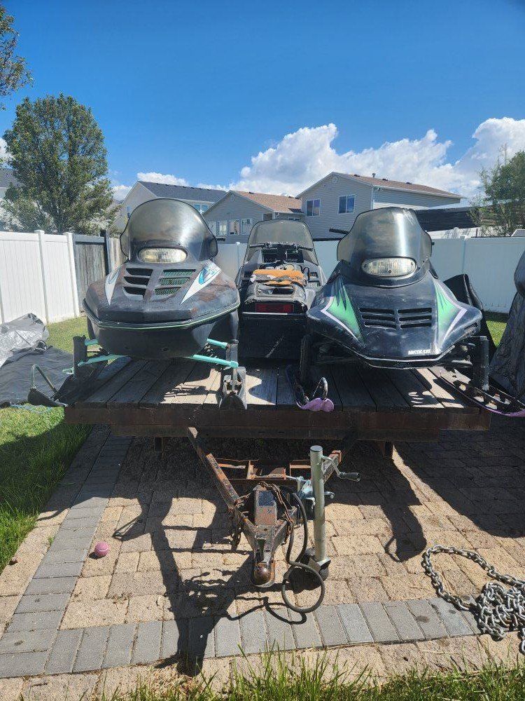 3 snowmobiles and trailer combo