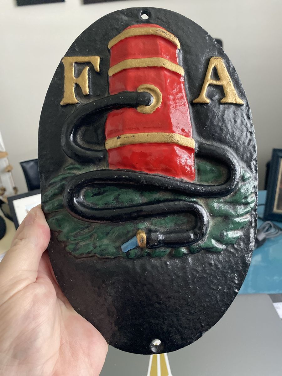 Cast iron fire insurance mark plaque with 'FA' lettering and fire hydrant motif